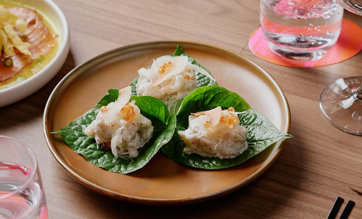 Prawn betel leaves with coconut and salmon pearls from the $65 Feed Me Menu