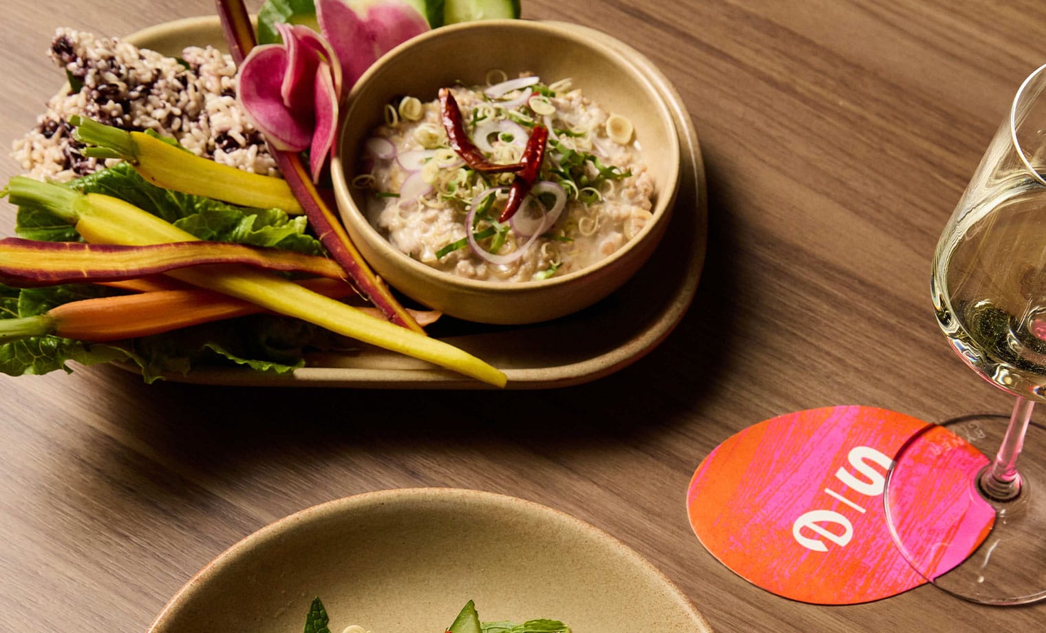 A signature Salted Egg dish plated with fresh herbs and pickled vegetables